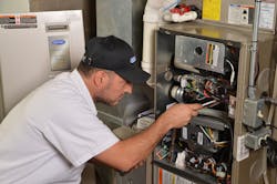 technician servicing furnace technician servicing furnace