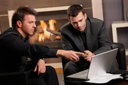 two men sales meeting laptop