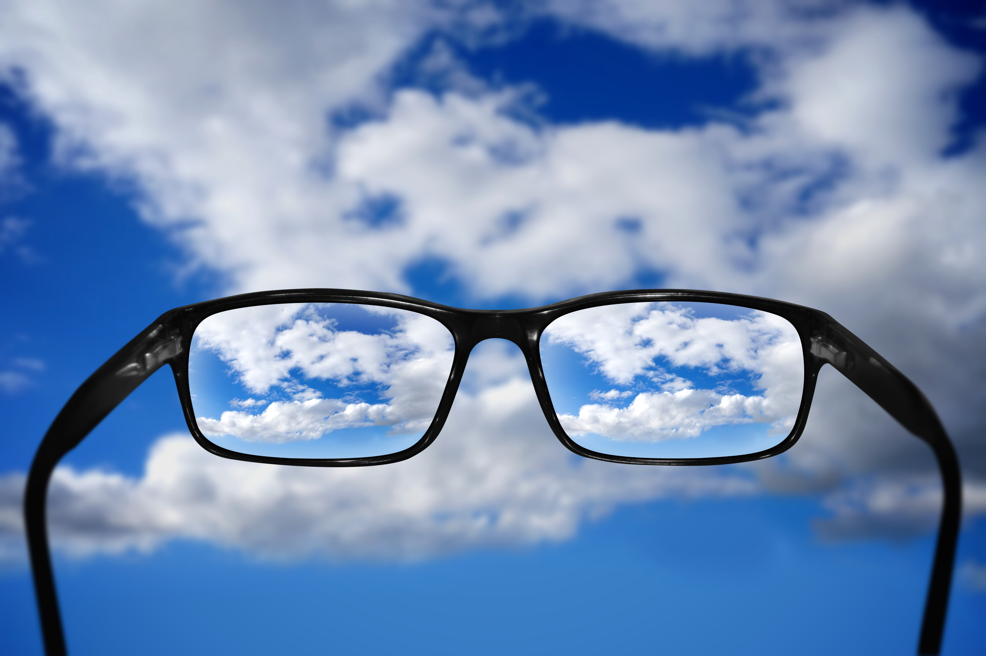 eyeglasses and cloudy sky