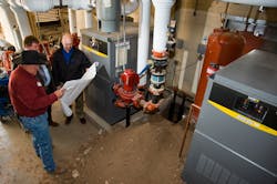 Jim Butler with SFPS General Services Don Swick ECI mechanical engineer and Dave Frederick ECI construction manager compare new boiler installation to design plans at Aspen Community Magnet School Jim Butler with SFPS General Services Don Swick ECI mechanical engineer and Dave Frederick ECI construction manager compare new boiler installation to design plans at Aspen Community Magnet School