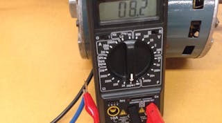Checking the windings on a motor using an ohmmeter.