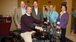 M.Todd Cramer, president of Johnstone Supply &ndash; Knoxville sits astride the Harley won by the company team. Awaiting their turns are (l to r), Rod Rushing, vice president and general manager Unitary Products at Johnson Controls; DeWight Wallace, CEO of Johnstone Supply; Tim Brusseau, UPG strategic distribution account manager at Johnson Controls; and Lori Hayes, product manager &ndash; HVAC equipment at Johnstone Supply.