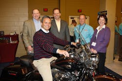 MTodd Cramer president of Johnstone Supply ndash Knoxville sits astride the Harley won by the company team Awaiting their turns are l to r Rod Rushing vice president and general manager Unitary Products at Johnson Controls DeWight Wallace CEO of Johnstone Supply Tim Brusseau UPG strategic distribution account manager at Johnson Controls and Lori Hayes product manager ndash HVAC equipment at Johnstone Supply MTodd Cramer president of Johnstone Supply ndash Knoxville sits astride the Harley won by the company team Awaiting their turns are l to r Rod Rushing vice president and general manager Unitary Products at Johnson Controls DeWight Wallace CEO of Johnstone Supply Tim Brusseau UPG strategic distribution account manager at Johnson Controls and Lori Hayes product manager ndash HVAC equipment at Johnstone Supply