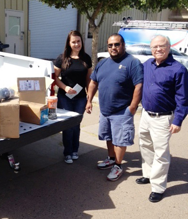 Katie Smith program manager with Foundation for Senior Living Mario Flores crew foreman with Goettl Good Guys Air Conditioning Repair and Dan Burke CEO of Goettl Good Guys