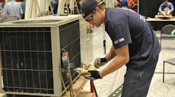 Tyler Plueger, winner of the 2013 PHCC Educational Foundation HVAC contest, takes readings on a package unit during the skills assessment portion of last year&rsquo;s competition.