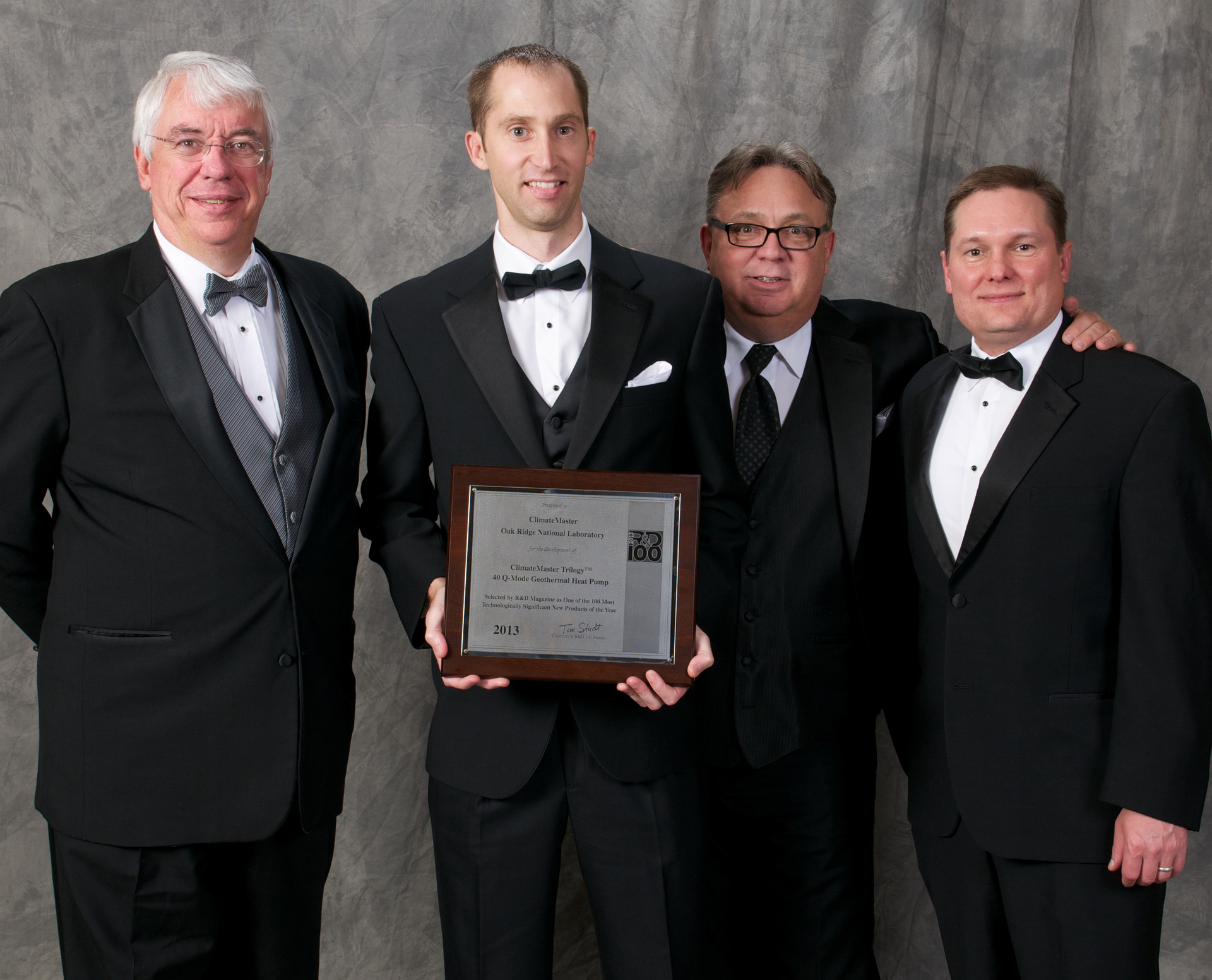 Shown with the RampD Magazine Award for the ClimateMaster Trilogy QMode geothermal heat pump system are from left Van Baxter senior engineer Oak Ridge National Laboratory ORNL Shawn Hern product engineer ClimateMaster John Bailey senior vice president sales ClimateMaster Wes Wostal vice president engineering ClimateMaster