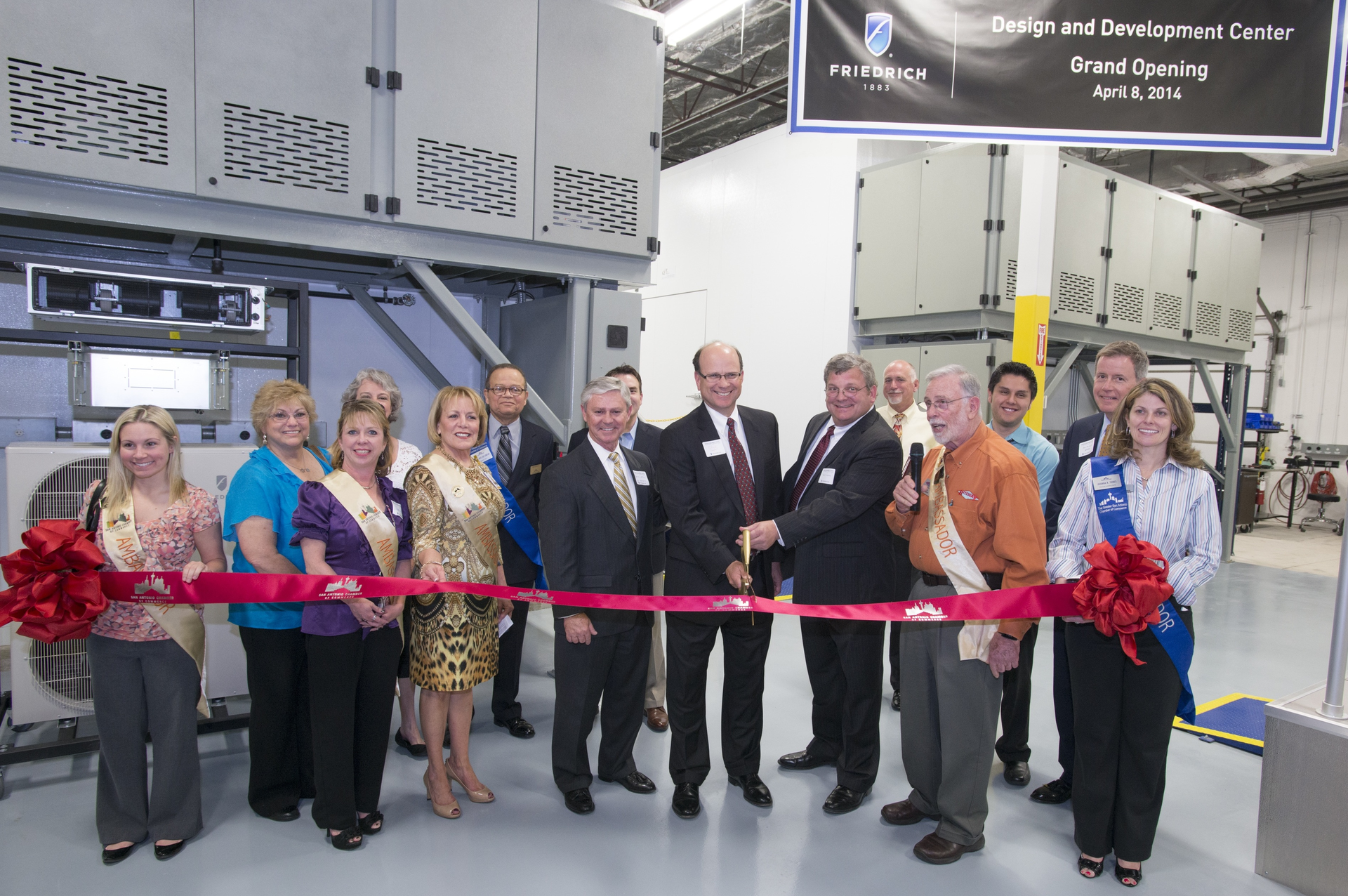 Friedrich Air Conditioning President Chuck Campbell center left and Vice President of Engineering David Lingrey center right cut the ribbon for the Design and Development Center grand opening joined by members of the San Antonio Chamber of CommerceBack row Friedrich Vice President of Sales and Marketing Wink Chapman Second row right Joe McGuire president Association of Home Appliance Manufacturers AHAM