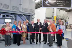 Friedrich Air Conditioning President Chuck Campbell center left and Vice President of Engineering David Lingrey center right cut the ribbon for the Design and Development Center grand opening joined by members of the San Antonio Chamber of CommerceBack row Friedrich Vice President of Sales and Marketing Wink Chapman Second row right Joe McGuire president Association of Home Appliance Manufacturers AHAM