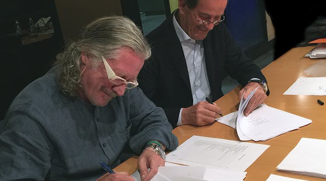 Taco&apos;s John Hazen White, Jr., left, and Elio Marioni of Askoll sign the acquisition agreement documents in Dueville, Italy.