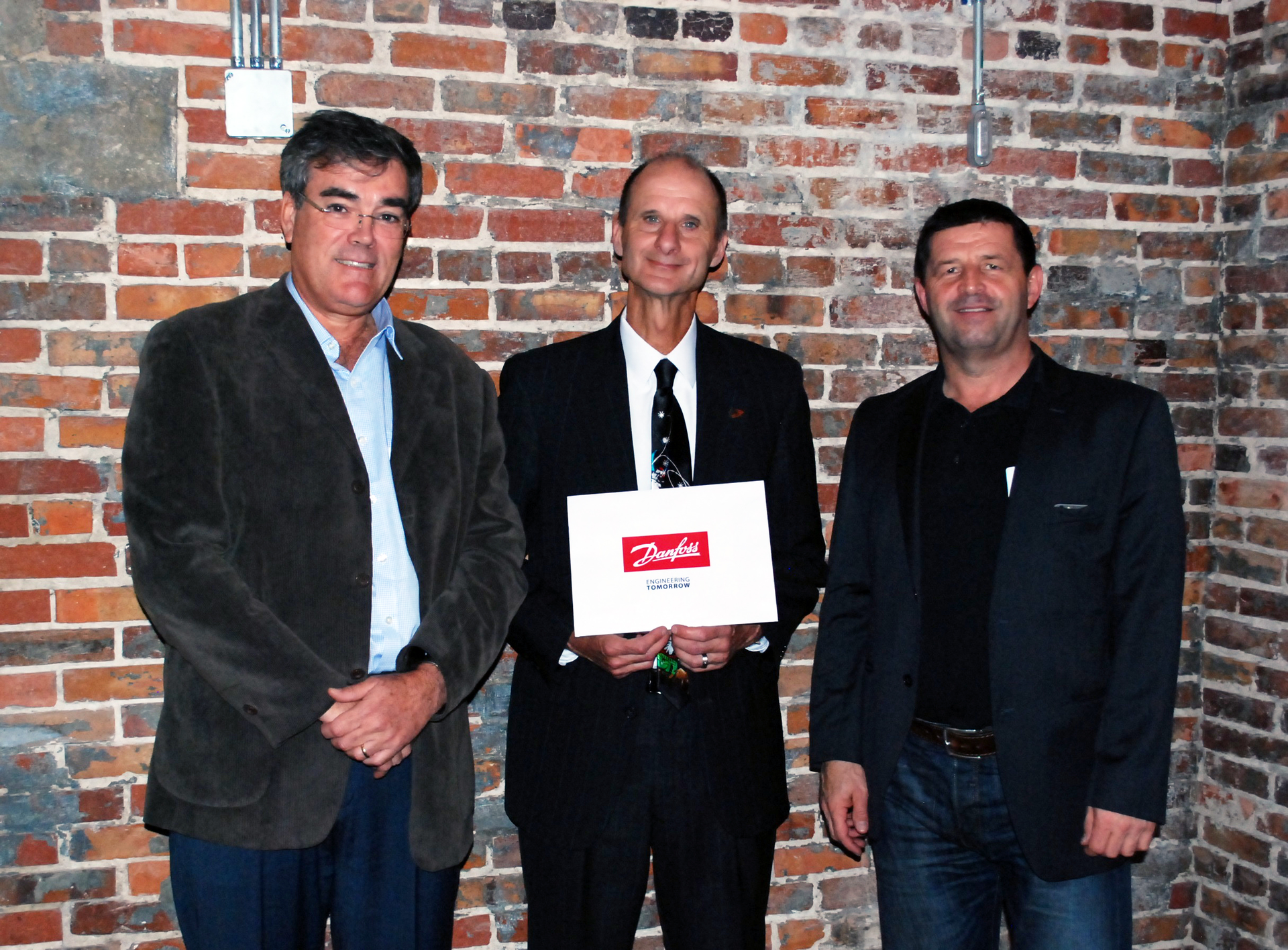 Pictured from left Ricardo Schneider president Danfoss Turbocor Compressors Dr Gary Ostrander vice president for research Florida State University and Jurgen Fischer president ndash cooling segment Danfoss