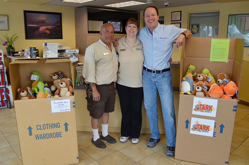George and Susan Perez managers at Storage West on Ann Road stand with Scott Meier coowner of Right Now Air and two boxes of stuffed animals donated by Right Now Air to the Tark Toy Drive on Friday April 8 2016