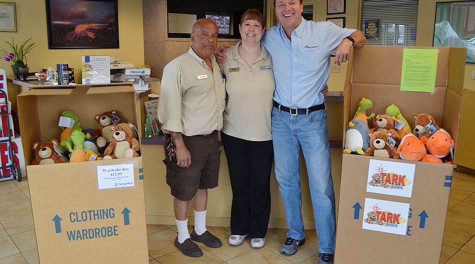 George and Susan Perez, managers at Storage West on Ann Road stand with Scott Meier, co-owner of Right Now Air, and two boxes of stuffed animals donated by Right Now Air to the Tark Toy Drive on Friday, April 8, 2016.