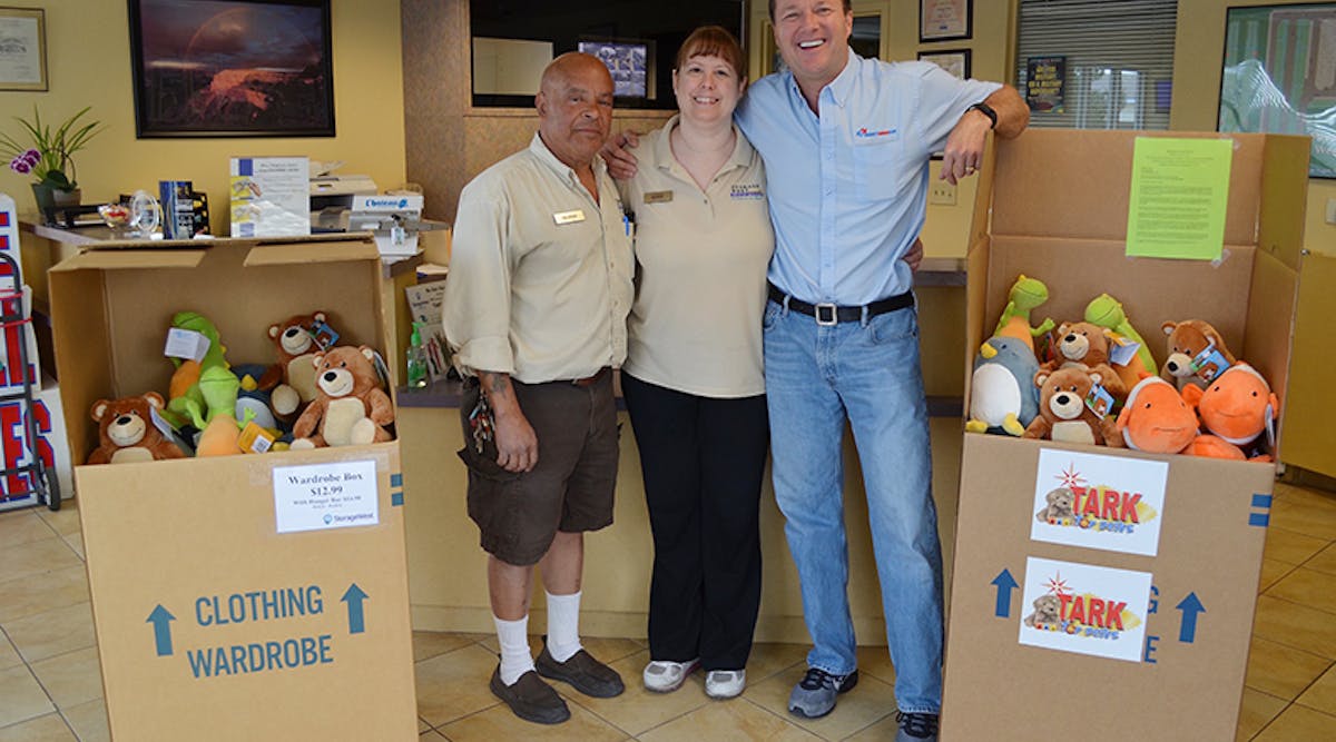 George and Susan Perez, managers at Storage West on Ann Road stand with Scott Meier, co-owner of Right Now Air, and two boxes of stuffed animals donated by Right Now Air to the Tark Toy Drive on Friday, April 8, 2016.