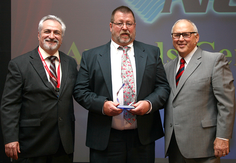 Tom Johnson center of TM Johnson Bros accepts the NCI Chairman39s Award from NCI CEO Dominick Guarino left and President Rob 39Doc39 Falke
