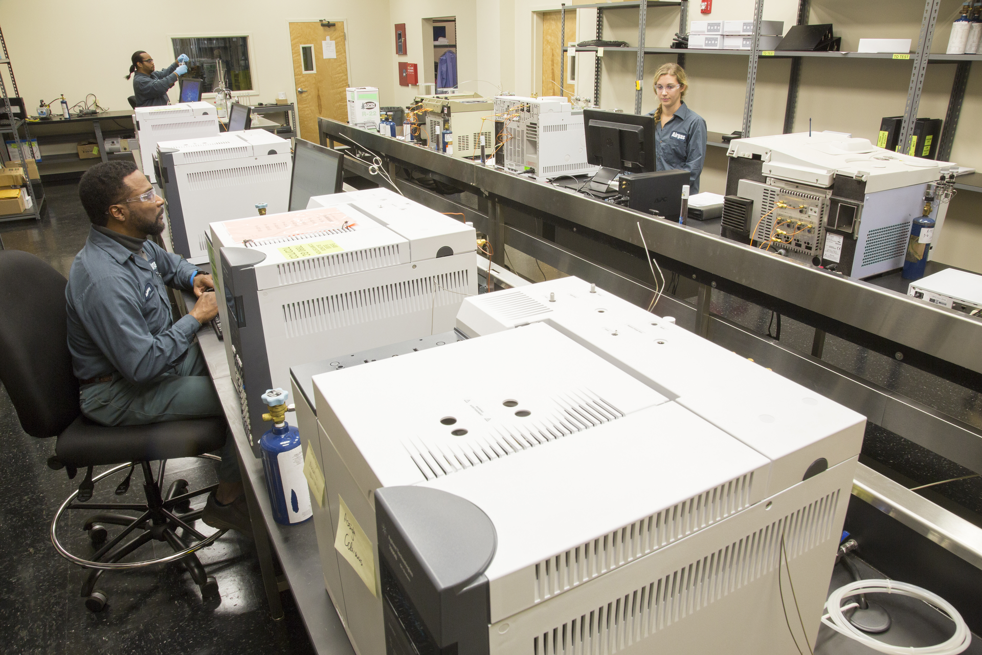 Anthony Duckworth foreground chemist Danielle Creel right and lab technician Magaja WIllis background test internal and customer refrigerant samples through mass spectrometers at Airgas Refrigerantsrsquo Atlanta production facility During one shift the lab can process about 25 analytical results with plans to scale test production