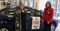 Leeza Crosby Edwards, left, and Natalie Tevis, President of Airclaws, Inc. and Bryant Heating &amp; Cooling Systems Medal of Excellence recipient, stand in front of the new Ford Fiesta donated to Leeza for her participation in the &apos;Dress for Success&apos; program.