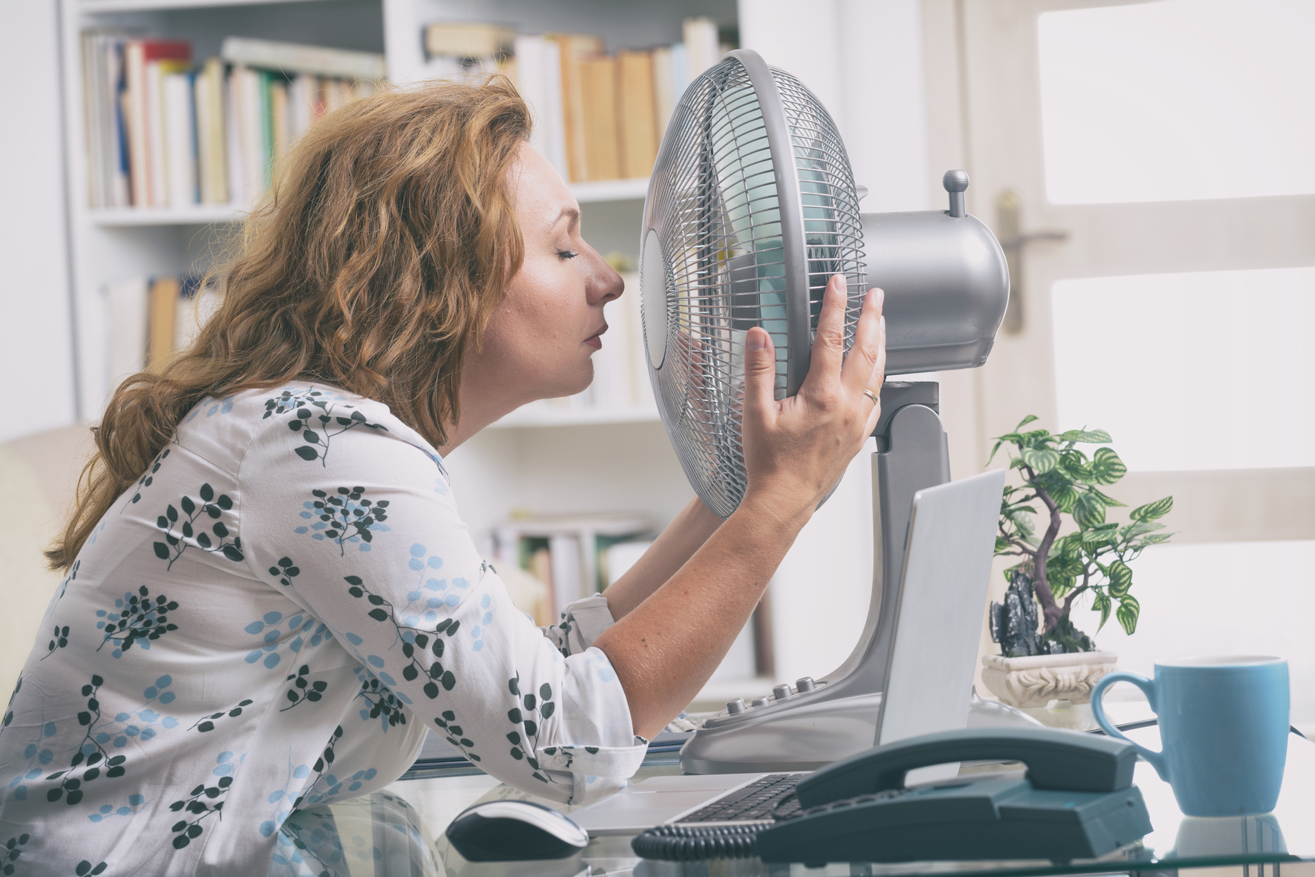 Woman with fan in office.jpg