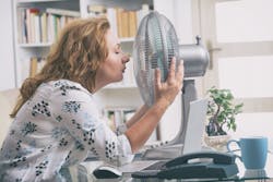 Woman with fan in office.jpg Woman with fan in office.jpg
