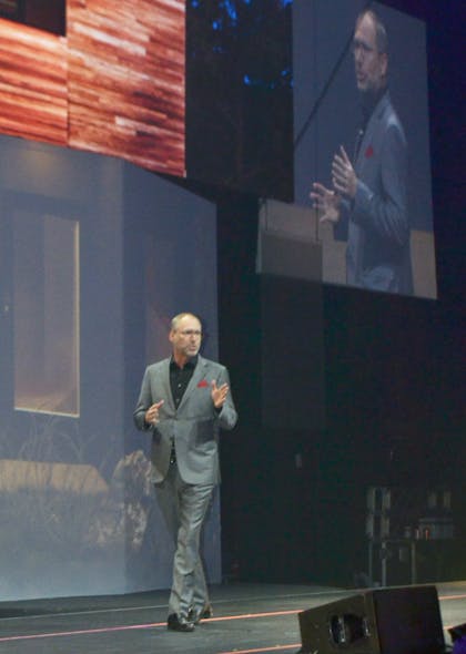 Mike Nefkens speaks to Resideo guests from the stage of The Moody Theater.