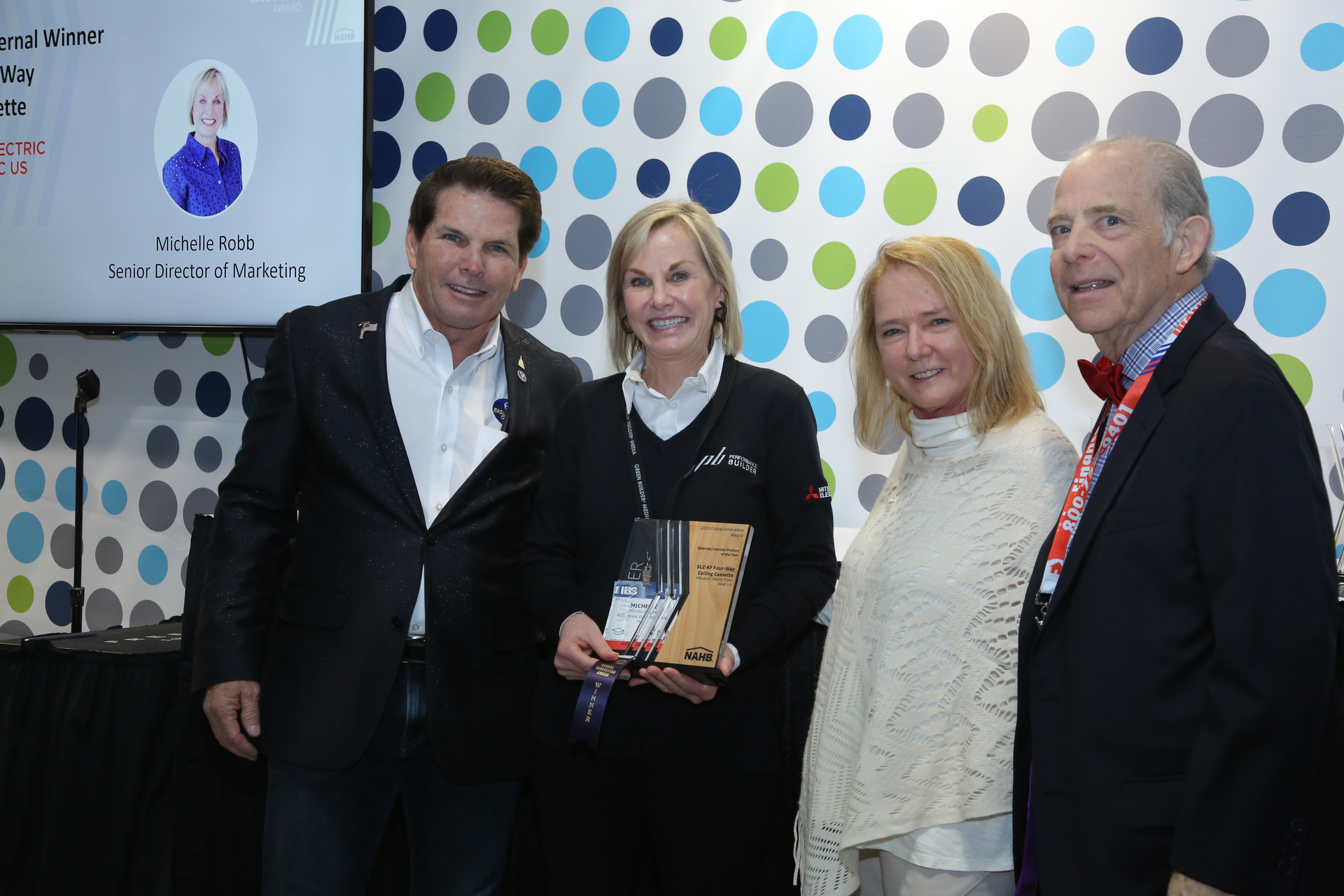 Receiving the innovation award are, from left to right: Dan Mitchell, Eagle CDI; Michelle Robb, Mitsubishi Electric Trane HVAC US; Jillian Pritchard Cooke, Wellness Within Your Walls,; and S. Robert August, North Star Synergies and Chair of NAHB Global Opportunities Board.