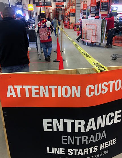 Shoppers wait their turn to checkout at a Home Depot, Cleveland, Oh. HD stores are limiting shoppers to 100 at any time.