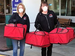 Employees of The Portland Group deliver pizzas to Elliot Hospital, prepared by 900 Degrees in Manchester, N.H. . Employees of The Portland Group deliver pizzas to Elliot Hospital, prepared by 900 Degrees in Manchester, N.H. .