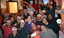 The AMHAC office and field technician team shown at a holiday party.