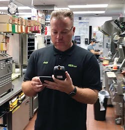 Jeff Sauerwein, operations manager at RES Vegas, checks the VOC level at a restaurant client&rsquo;s location. The company studies this level before and after the installation of bipolar ionization equipment.