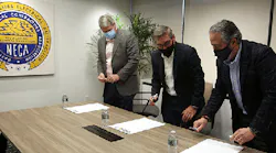 MCAA's Timothy Brink, TAUC's Steve Lindauer and NECA's David Long prepare to sign the strategic alliance agreement