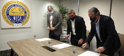 MCAA's Timothy Brink, TAUC's Steve Lindauer and NECA's David Long prepare to sign the strategic alliance agreement MCAA's Timothy Brink, TAUC's Steve Lindauer and NECA's David Long prepare to sign the strategic alliance agreement