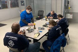 Center for Family Love (CFL) job coach Muffy (standing) oversees air handler light fixture assembly work at Nortek Air Solutions by CFL residents (left to right) Stanley, Jeremy, Dorothy and Maria. (Photo Credit: Nortek Air Solutions) Center for Family Love (CFL) job coach Muffy (standing) oversees air handler light fixture assembly work at Nortek Air Solutions by CFL residents (left to right) Stanley, Jeremy, Dorothy and Maria. (Photo Credit: Nortek Air Solutions)