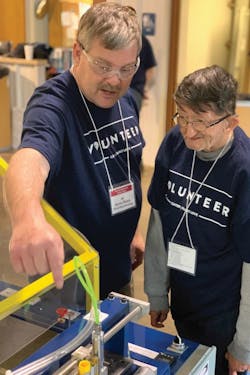 Kevin Flynn describes the operation of the filter pleating machine to David. Kevin Flynn describes the operation of the filter pleating machine to David.