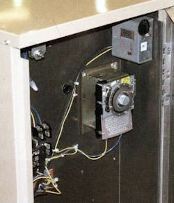 Defrost timer installed in a commercial refrigeration system&apos;s condensing unit.