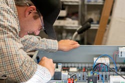 Nomad technician Dustin works on system settings. Nomad technician Dustin works on system settings.
