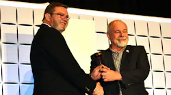 Steve Pape, right, passes the ACCA Chairman's gavel to 2024-25 ACCA Chairman Martin Hoover.