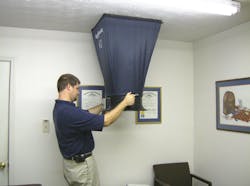 Photo 1: Delivered airflow into the living space is the core test in measuring system performance. A much younger David Richardson measures airflow from a supply register for demonstration purposes. Photo 1: Delivered airflow into the living space is the core test in measuring system performance. A much younger David Richardson measures airflow from a supply register for demonstration purposes.