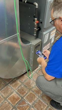 NCI Instructor Rob Minnick measures return duct static pressure while using the TrueFlow app from The Energy Conservatory. NCI Instructor Rob Minnick measures return duct static pressure while using the TrueFlow app from The Energy Conservatory.