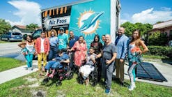 Families that have received home AC systems, Air Pro employees and Miami Dolphins cheerleaders pose for photo. Families that have received home AC systems, Air Pro employees and Miami Dolphins cheerleaders pose for photo.