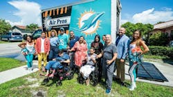 Families that have received home AC systems, Air Pro employees and Miami Dolphins cheerleaders pose for photo. Families that have received home AC systems, Air Pro employees and Miami Dolphins cheerleaders pose for photo.