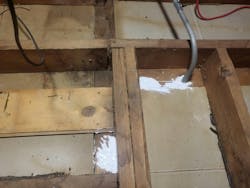 Photo 3. Air sealing the electrical penetrations in the attic with caulk. Photo 3. Air sealing the electrical penetrations in the attic with caulk.