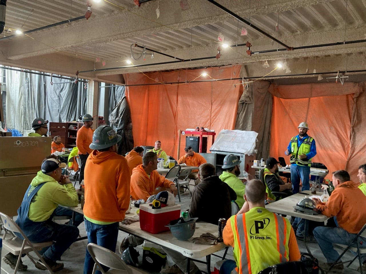 P1 Construction holds a safety meeting with employees.