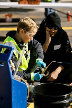A camp attendee using an oxy-acetylene torch. A camp attendee using an oxy-acetylene torch.
