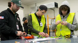 Camp attendees working with electrical components.