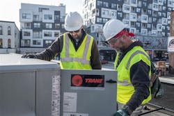 Trane technicians work on an HVAC system. Trane technicians work on an HVAC system.