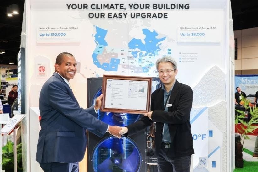 Carl Bloomfield presenting Intertek's first Global CVP Compliance Certificate for Air Conditioners to Phil Huang at the 2025 AHR Expo.
