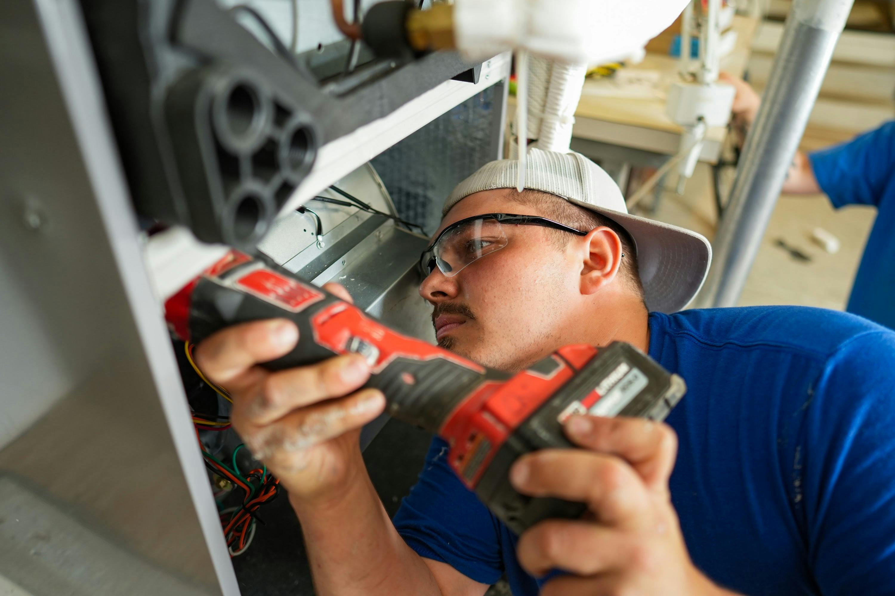 A contractor installs a heat pump.
