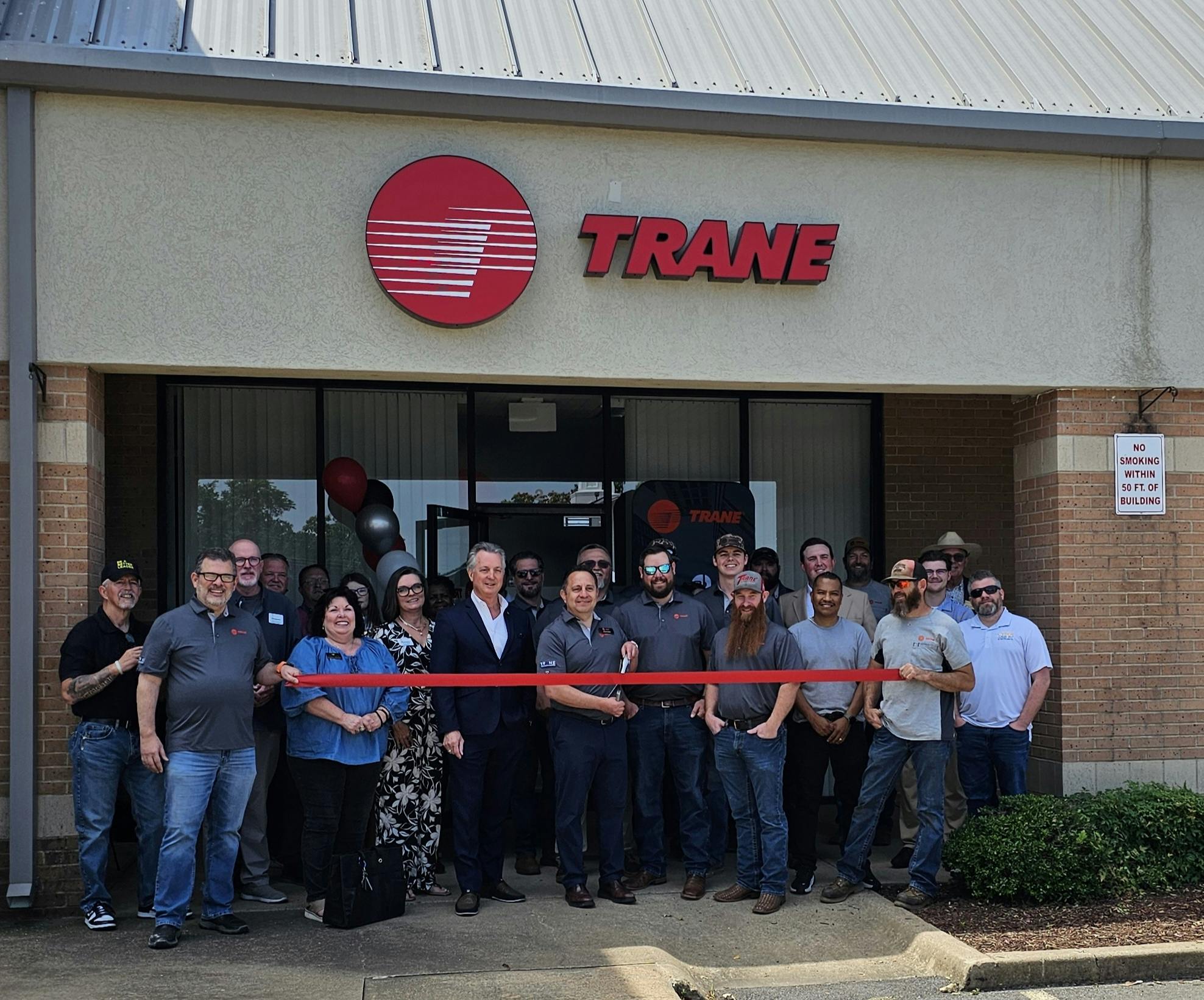 Trane team members take part in a ribbon-cutting ceremony during the grand opening celebration of the new Trane sales and distribution office in Fort Smith, Arkansas, on May 14.